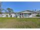 Front view of a renovated home with a covered porch at 3207 Acacia St, Lutz, FL 33558