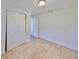 Well-lit bedroom with double door closet and tile floors at 3207 Acacia St, Lutz, FL 33558
