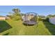 Spacious backyard featuring a trampoline and storage shed at 3207 Acacia St, Lutz, FL 33558