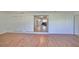 Bonus room with laminate floors and view into the kitchen and living room at 3207 Acacia St, Lutz, FL 33558
