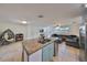 Modern kitchen with granite island, stainless steel appliances, and open floor plan at 3207 Acacia St, Lutz, FL 33558