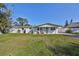 Charming ranch house with a covered porch and well-maintained lawn at 3207 Acacia St, Lutz, FL 33558