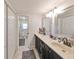 Double vanity bathroom with dark cabinets and beige countertops at 3207 Acacia St, Lutz, FL 33558