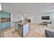 Spacious kitchen with granite island, stainless steel appliances, and teal cabinets at 3207 Acacia St, Lutz, FL 33558