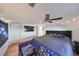 Main bedroom with king bed, blue sofa, and hardwood floors at 3207 Acacia St, Lutz, FL 33558