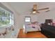 Charming bedroom with wood floors, ceiling fan and large window at 3207 Acacia St, Lutz, FL 33558