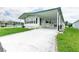 Front view of a white manufactured home with a carport at 37617 Amigo Dr, Zephyrhills, FL 33541