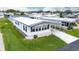 An elevated view of a white manufactured home in a neighborhood at 37617 Amigo Dr, Zephyrhills, FL 33541