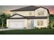 Charming two-story home with a two-car garage, light yellow siding, and a well-manicured lawn at 4206 Feldspar Ln, Spring Hill, FL 34609