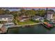 Expansive waterfront property with lush landscaping, a private dock, boat lift, and pool at 52 Sandpiper Rd, Tampa, FL 33609
