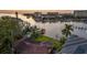 A waterfront home has boatlifts and docks, lush landscaping, and canal access to the bay at 52 Sandpiper Rd, Tampa, FL 33609