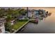 Stunning waterfront property featuring a private dock, boat lift, lush landscaping, and a backyard pool at 52 Sandpiper Rd, Tampa, FL 33609