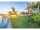 Waterfront home boasts lush lawn, mature palms, and private dock for tranquil outdoor living at 52 Sandpiper Rd, Tampa, FL 33609