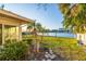 Lush backyard with tropical plants on the water at 52 Sandpiper Rd, Tampa, FL 33609