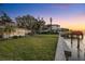 Expansive backyard features a lush lawn, convenient dock, and waterfront access at 52 Sandpiper Rd, Tampa, FL 33609