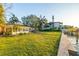 Serene backyard featuring a lush lawn, private dock, and convenient access to Tampa Bay at 52 Sandpiper Rd, Tampa, FL 33609