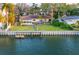 Waterfront home boasts lush landscaping, seawall, and private dock access at 52 Sandpiper Rd, Tampa, FL 33609