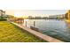 Waterfront panorama features the sunset over the channel with boats docked at the pier at 52 Sandpiper Rd, Tampa, FL 33609