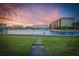 Scenic waterfront view with well-maintained grassy area under a vibrant sunset at 52 Sandpiper Rd, Tampa, FL 33609