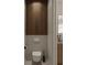 Small modern bathroom with wood and marble accents, a floating toilet, and decorative mosaic tiling at 7176 S Shore Dr, South Pasadena, FL 33707