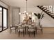 Elegant dining area with contemporary lighting, stylish decor, and seamless access to the outdoors at 7176 S Shore Dr, South Pasadena, FL 33707