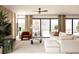 Bright living room with modern decor, large windows, neutral colors, and comfortable seating at 7176 S Shore Dr, South Pasadena, FL 33707