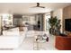 Bright, open-concept living room featuring modern decor, a sleek kitchen, and large windows for ample natural light at 7176 S Shore Dr, South Pasadena, FL 33707