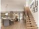 A bright, open-concept living room and dining area with modern staircase and light hardwood floors at 7176 S Shore Dr, South Pasadena, FL 33707
