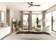 Calm main bedroom with soft hues, ample natural light, and relaxing seating area at 7176 S Shore Dr, South Pasadena, FL 33707