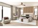 Comfortable main bedroom featuring a modern ceiling fan, a decorative wood wall and ample natural light at 7176 S Shore Dr, South Pasadena, FL 33707