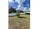 Spacious backyard with a shed and a white fence at 7906 Gulf Way, Hudson, FL 34667