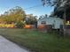 Mobile home with fenced yard and mature trees at 9131 Kosimo St, New Port Richey, FL 34654