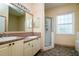 Bathroom with double sinks, shower, and a large mirror at 10803 Australian Pine Dr, Riverview, FL 33579