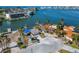 Waterfront property with a home, neighboring houses, and boat in the canal at 12520 4Th E St, Treasure Island, FL 33706
