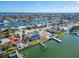 Aerial view of waterfront home with private dock and solar panels at 12520 4Th E St, Treasure Island, FL 33706