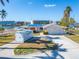 House with attached garage, a storage container is present in the front yard at 12520 4Th E St, Treasure Island, FL 33706
