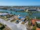 Aerial view of waterfront property with canal access and nearby buildings at 12520 4Th E St, Treasure Island, FL 33706
