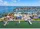 Aerial view showcasing a waterfront property with a private dock at 12520 4Th E St, Treasure Island, FL 33706