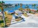 Waterfront home with damaged roof and a storage container at 12520 4Th E St, Treasure Island, FL 33706