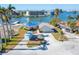 Waterfront home with damaged roof and storage container at 12520 4Th E St, Treasure Island, FL 33706