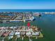Aerial view of waterfront home with access to the ocean, a canal and neighboring homes at 12520 4Th E St, Treasure Island, FL 33706