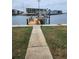Concrete walkway leading to a private dock on the water at 12520 4Th E St, Treasure Island, FL 33706
