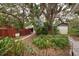 Landscaped backyard with a wooden fence and lush greenery at 1311 E Park Cir, Tampa, FL 33604