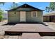 Backyard with grass, sand, a wooden fence and a small deck at 1312 E Louise Ave, Tampa, FL 33603