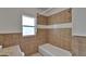 This bathroom has a tiled shower and bathtub combination with updated tiling at 1312 E Louise Ave, Tampa, FL 33603