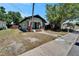Charming home with a quaint porch, complemented by lush landscaping and a well-manicured lawn at 1312 E Louise Ave, Tampa, FL 33603