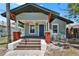 Charming single-story home with a covered front porch and brick-accented columns at 1312 E Louise Ave, Tampa, FL 33603