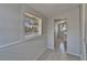 Hallway with tile floor, windows, and a view of the laundry room at 1312 E Louise Ave, Tampa, FL 33603