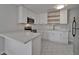 The kitchen features white cabinets, stainless steel appliances, quartz countertops, and modern subway tile at 1312 E Louise Ave, Tampa, FL 33603