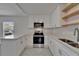 A kitchen with stainless steel appliances, subway tile backsplash, and quartz countertops at 1312 E Louise Ave, Tampa, FL 33603